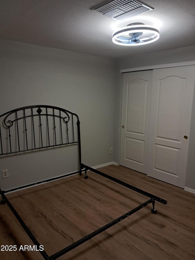 unfurnished bedroom featuring a closet and wood-type flooring