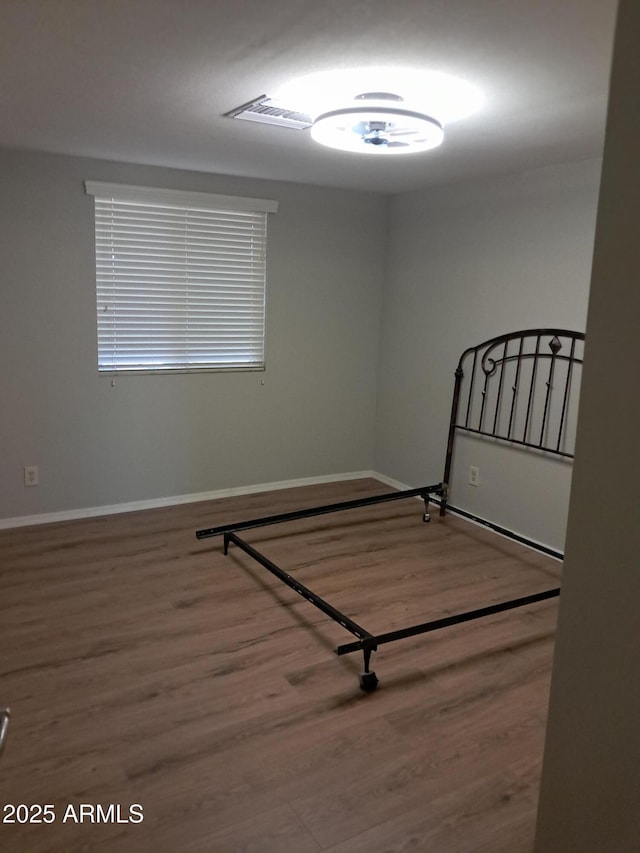 unfurnished bedroom featuring hardwood / wood-style flooring