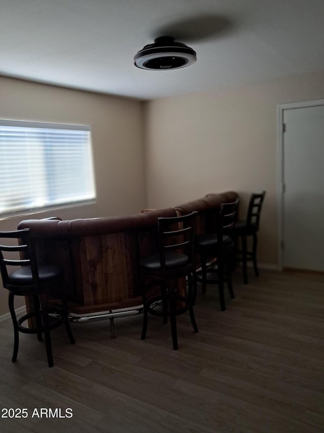 dining room featuring bar area and hardwood / wood-style flooring