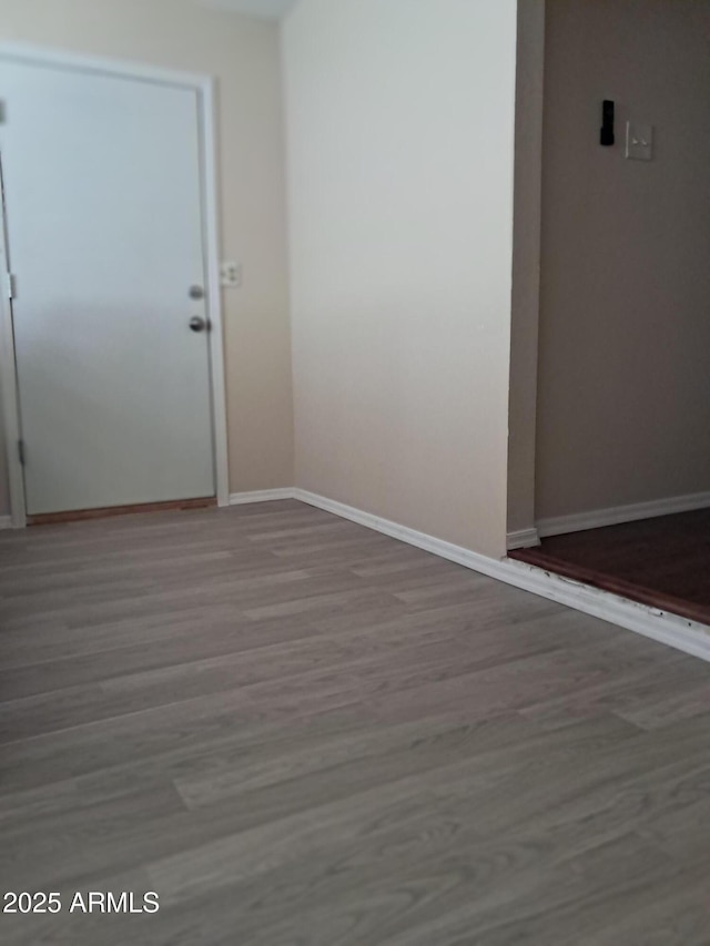 spare room featuring wood-type flooring