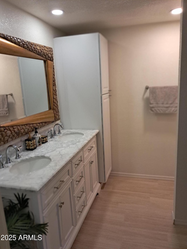 bathroom featuring wood-type flooring and vanity