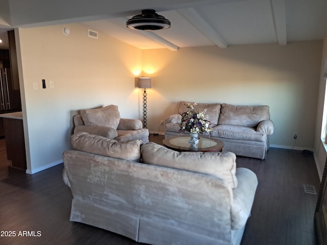 living room featuring dark hardwood / wood-style flooring and beam ceiling