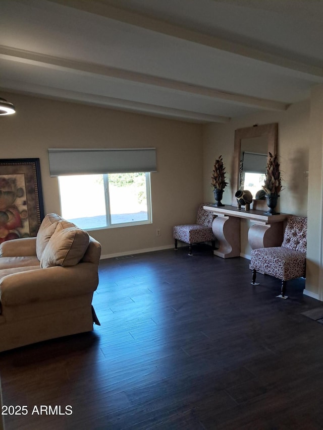 sitting room featuring beamed ceiling and dark hardwood / wood-style floors