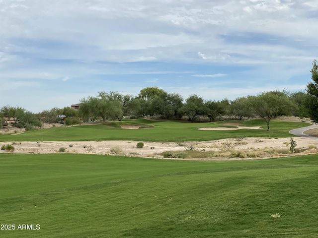 view of community with a lawn and golf course view