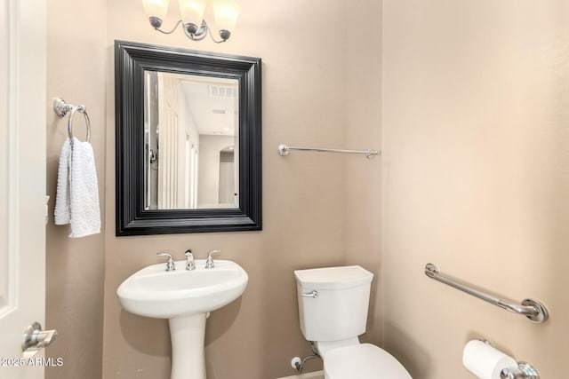 bathroom featuring toilet and a sink