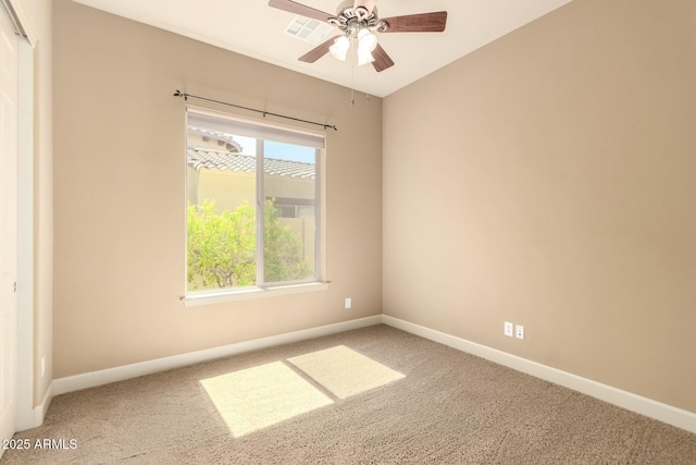 empty room with carpet, ceiling fan, and baseboards