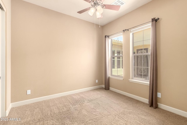 unfurnished room with carpet floors, a ceiling fan, and baseboards