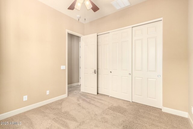unfurnished bedroom featuring carpet flooring, baseboards, and a closet