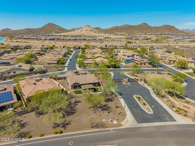 aerial view of property's location with nearby suburban area and a mountain backdrop