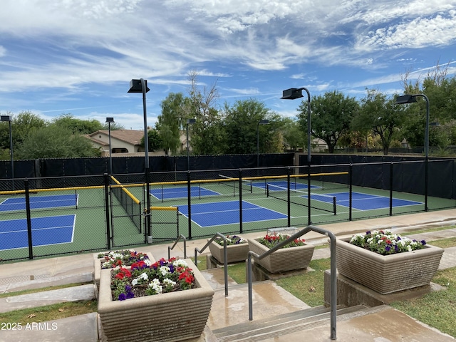 view of tennis court featuring fence