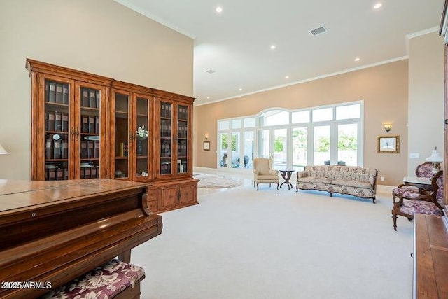 sitting room featuring recessed lighting, carpet, a towering ceiling, and ornamental molding