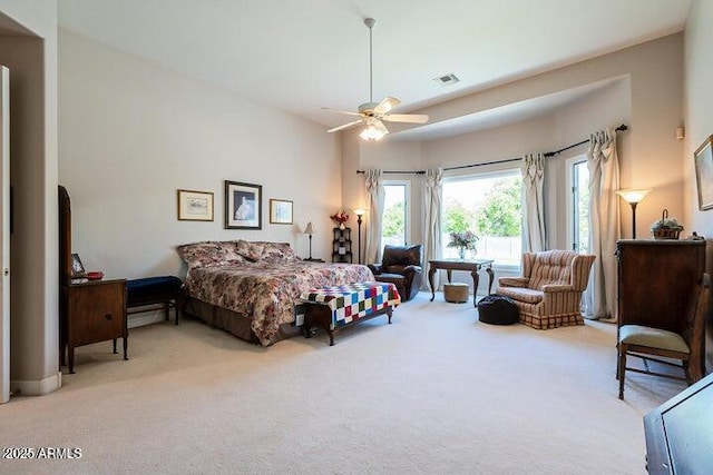 bedroom featuring visible vents, light carpet, and a ceiling fan