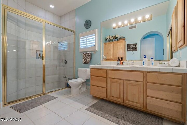 bathroom featuring vanity, visible vents, a shower stall, tile patterned floors, and toilet