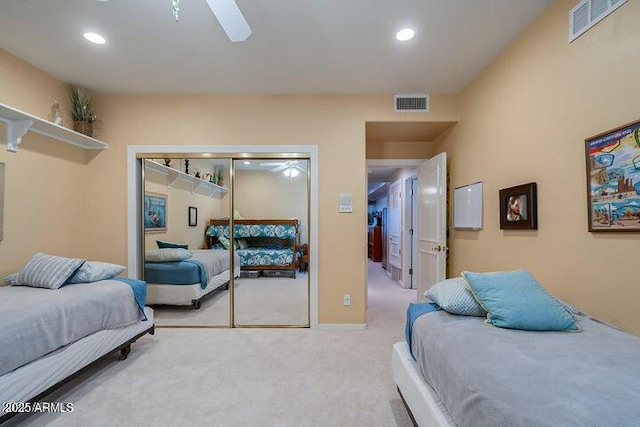 bedroom featuring light carpet, visible vents, recessed lighting, and a closet