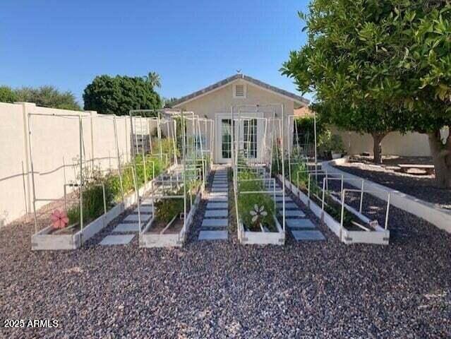 exterior space featuring a vegetable garden and fence private yard