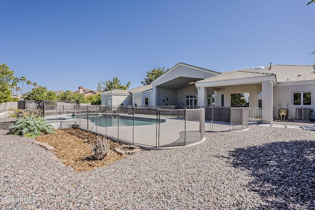 view of swimming pool with central AC unit, fence, a patio, and a fenced in pool