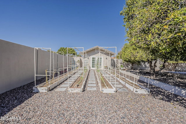 view of yard with a vegetable garden and a fenced backyard