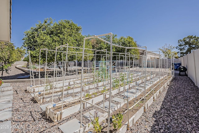 view of yard featuring a vegetable garden and fence