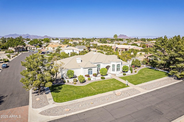 birds eye view of property with a mountain view and a residential view