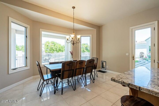 dining space featuring light tile patterned floors, a healthy amount of sunlight, and baseboards