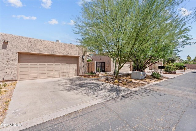 2313 S Grandview Ave, Tempe, AZ 85282 - pueblo revival-style home featuring concrete driveway, stucco siding, and an attached garage