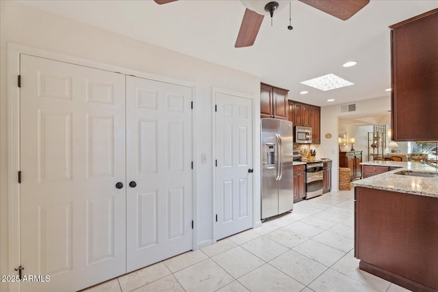 2313 S Grandview Ave, Tempe, AZ 85282 - kitchen with stainless steel appliances, ceiling fan, recessed lighting, light stone counters, and light tile patterned flooring