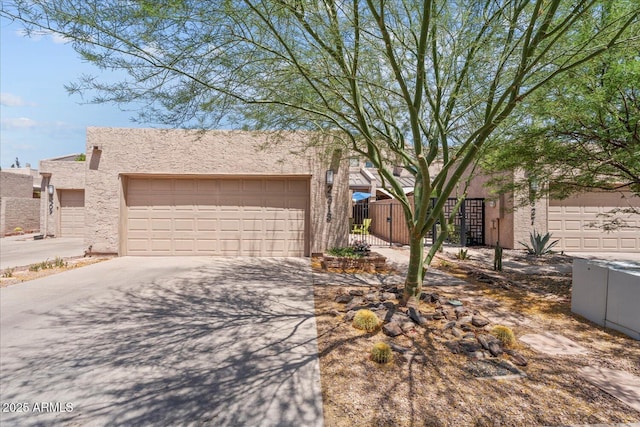 2313 S Grandview Ave, Tempe, AZ 85282 - view of front facade with stucco siding, a gate, concrete driveway, and an attached garage