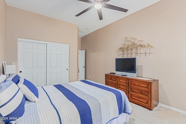 carpeted bedroom featuring a closet and ceiling fan