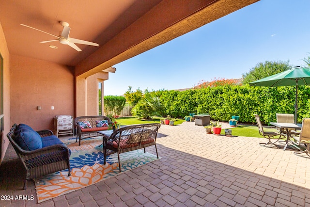 view of patio / terrace with ceiling fan and an outdoor living space