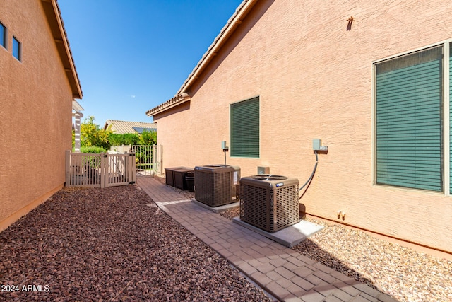 view of patio with a hot tub and central AC