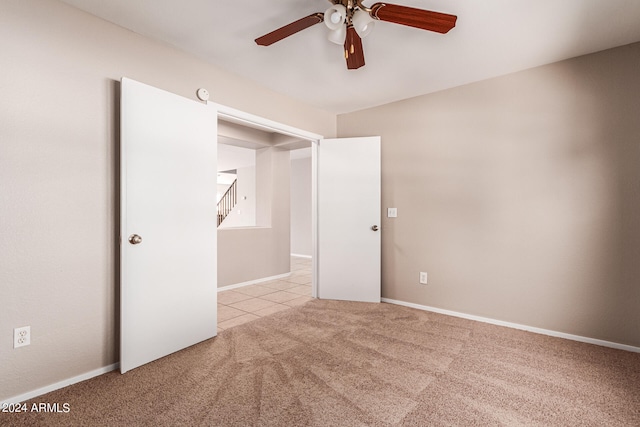 unfurnished bedroom with ceiling fan and light carpet