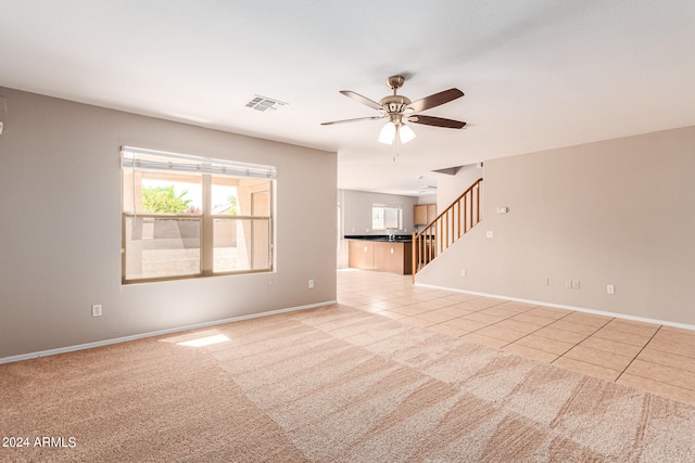 unfurnished living room with ceiling fan and light tile patterned flooring