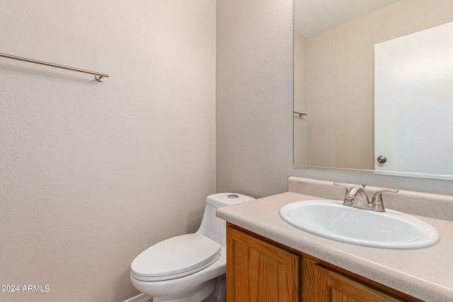 bathroom featuring toilet and vanity