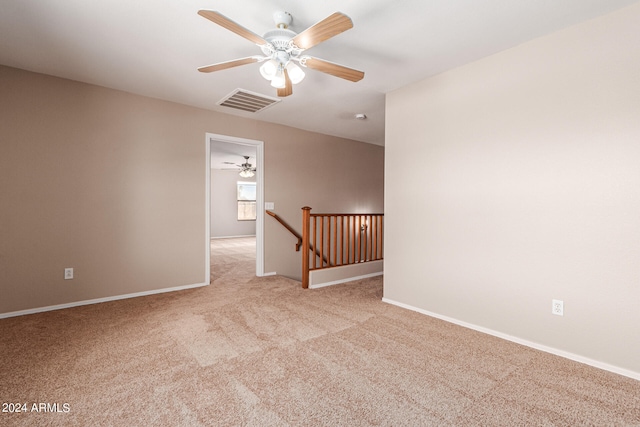 empty room featuring light carpet and ceiling fan