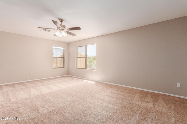 carpeted empty room featuring ceiling fan