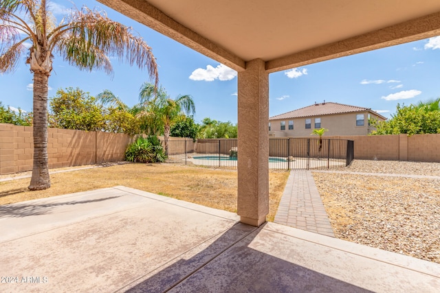 view of patio / terrace with a fenced in pool