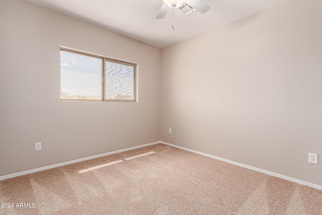 carpeted spare room with ceiling fan