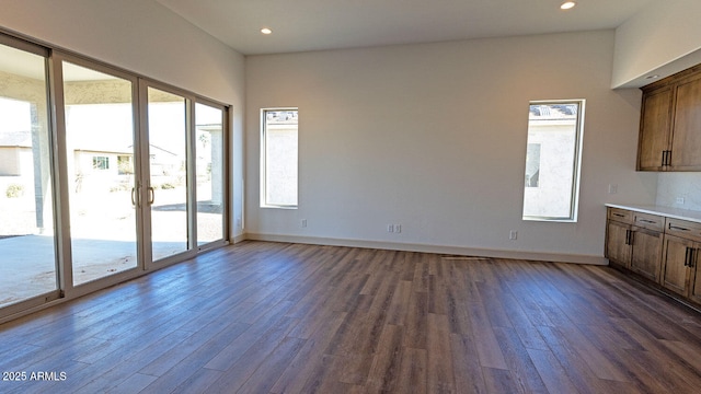 interior space with recessed lighting, baseboards, and dark wood-style floors