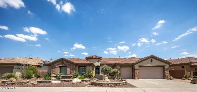 view of front of home with a garage, stone siding, a tile roof, and stucco siding