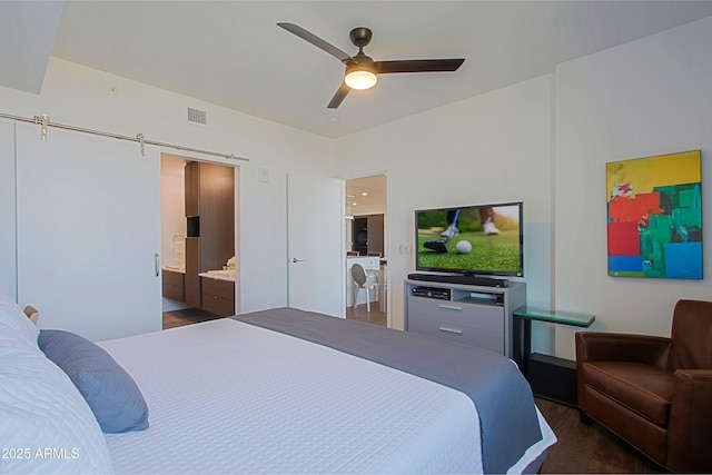 200 W Portland St Unit 1024, Phoenix, AZ 85003 - bedroom featuring ceiling fan, connected bathroom, and wood finished floors