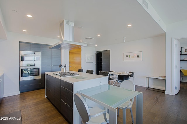 200 W Portland St Unit 1024, Phoenix, AZ 85003 - kitchen featuring modern cabinets, appliances with stainless steel finishes, island exhaust hood, a center island, and baseboards