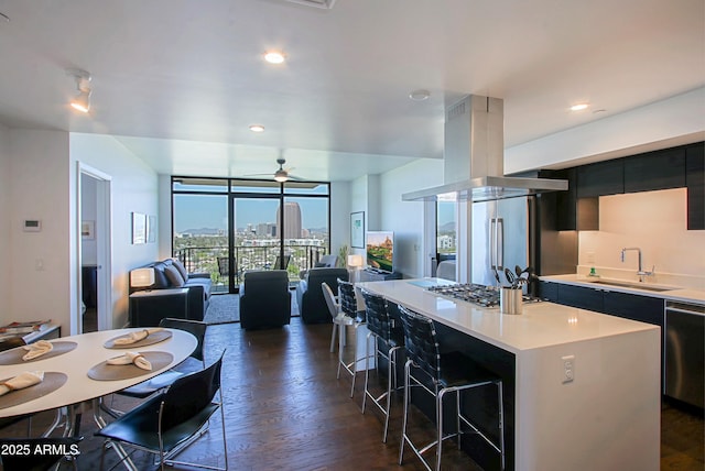 200 W Portland St Unit 1024, Phoenix, AZ 85003 - kitchen featuring modern cabinets, a wall of windows, a sink, dark cabinetry, and island range hood