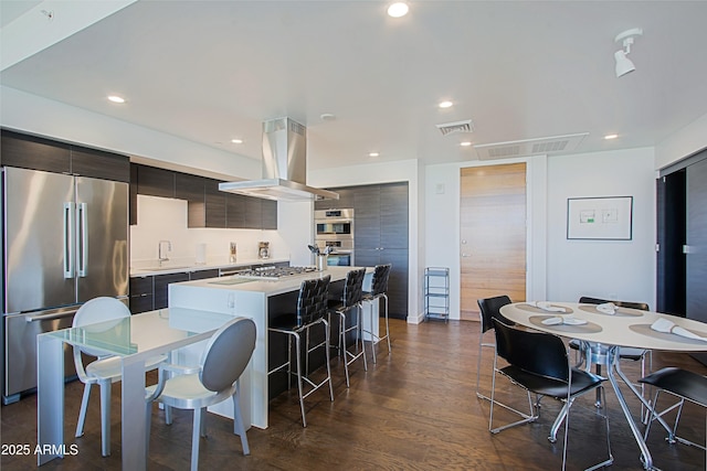 200 W Portland St Unit 1024, Phoenix, AZ 85003 - kitchen featuring appliances with stainless steel finishes, modern cabinets, island range hood, a kitchen breakfast bar, and recessed lighting