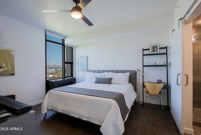200 W Portland St Unit 1024, Phoenix, AZ 85003 - bedroom featuring a barn door, dark wood-style flooring, baseboards, and a ceiling fan