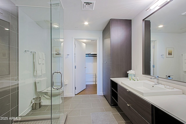 200 W Portland St Unit 1024, Phoenix, AZ 85003 - bathroom featuring vanity, a stall shower, tile patterned flooring, a spacious closet, and recessed lighting