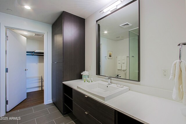 200 W Portland St Unit 1024, Phoenix, AZ 85003 - bathroom featuring vanity, tile patterned flooring, and a spacious closet