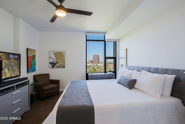 200 W Portland St Unit 1024, Phoenix, AZ 85003 - bedroom featuring dark wood-style flooring, baseboards, ceiling fan, floor to ceiling windows, and a city view