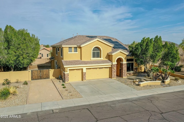 view of front facade featuring stucco siding, a gate, stone siding, and a garage