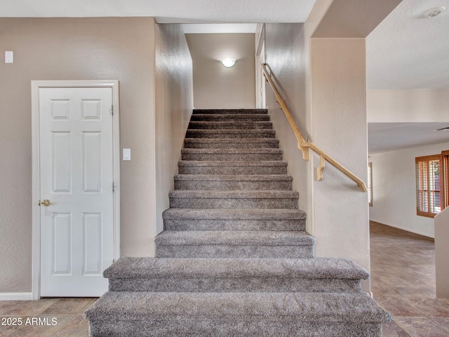 stairs featuring baseboards