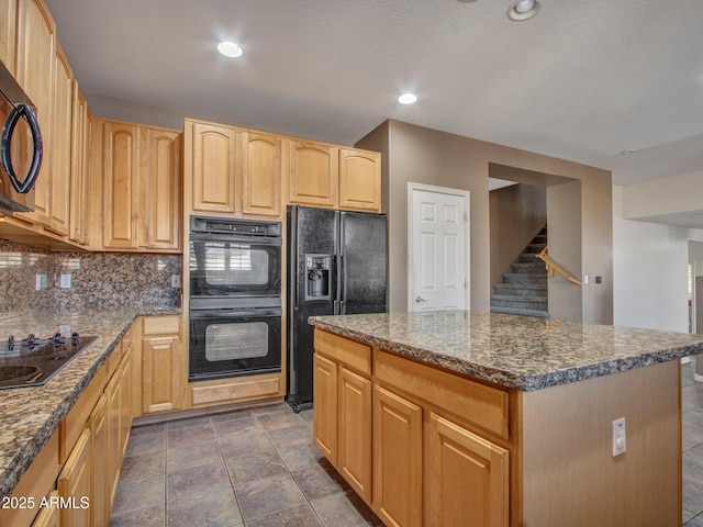 kitchen with recessed lighting, a kitchen island, tasteful backsplash, black appliances, and light brown cabinetry